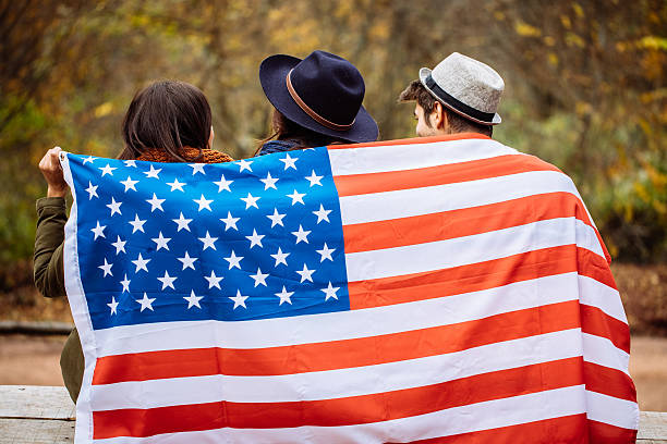 istock Friends sitting wrapped in american flag 621854120