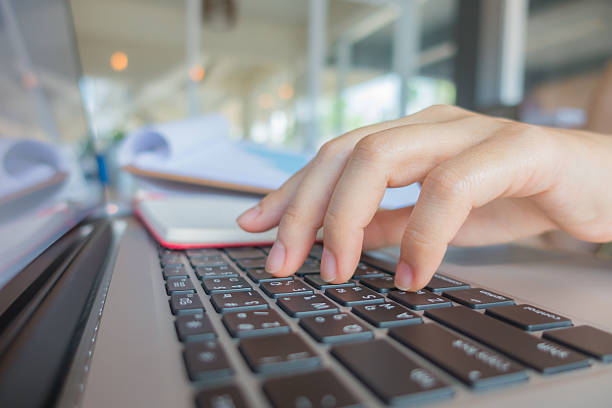 istock Closeup of hands typing and writing 621854262