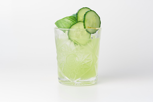 Cucumber Basil Smash Cocktail, consisting of gin, basil, cucumber, simple syrup and lemon juice