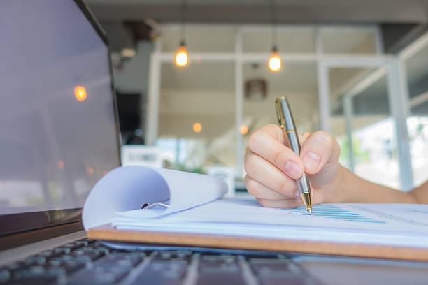 istock Closeup of hands typing and writing 621854550