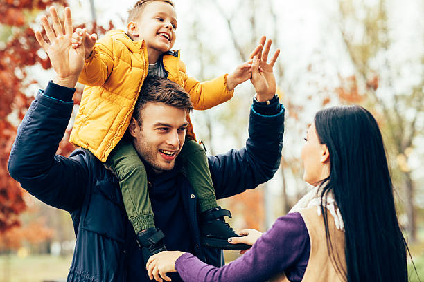 istock Young family have fun in park 621856634