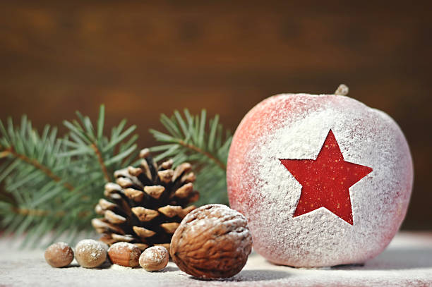 istock Christmas card with apple, nuts and pinecone 621856744
