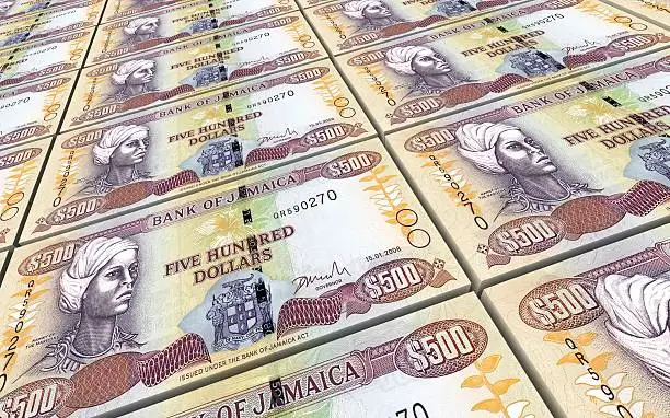 Photo of Jamaican dollar bills stacks background.