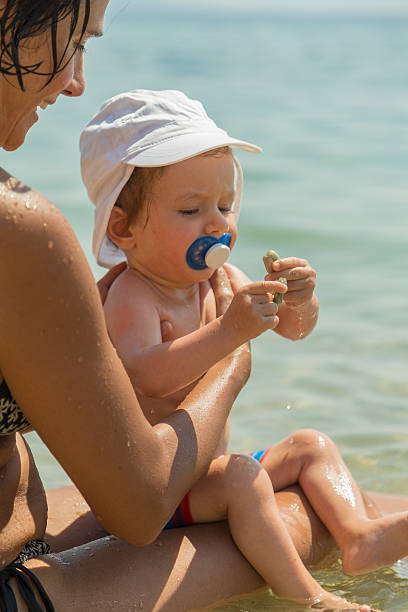 istock Mother and son having fun in sea 621857934