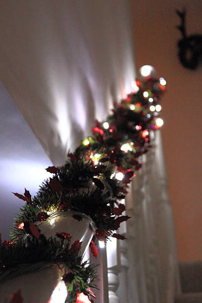 istock Christmas Lights & Festive Tinsel Wrapped Around Banister 621858116