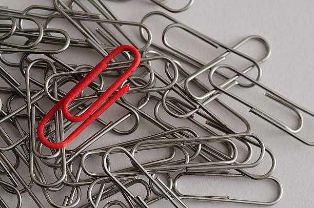 istock Steel paper clips with a single red paperclip 621858852
