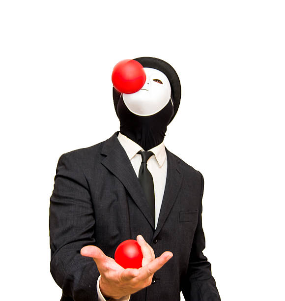 istock Businessman with a white mask and a hat Juggling with 621858854