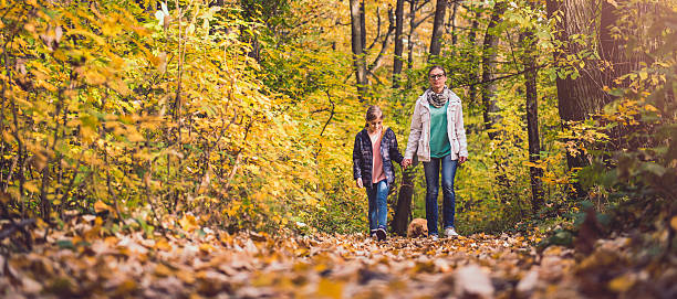 istock Mother and daughter hiking in a forest 621858874