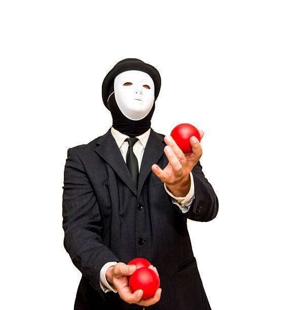 istock Businessman with a white mask and a hat Juggling with 621859040