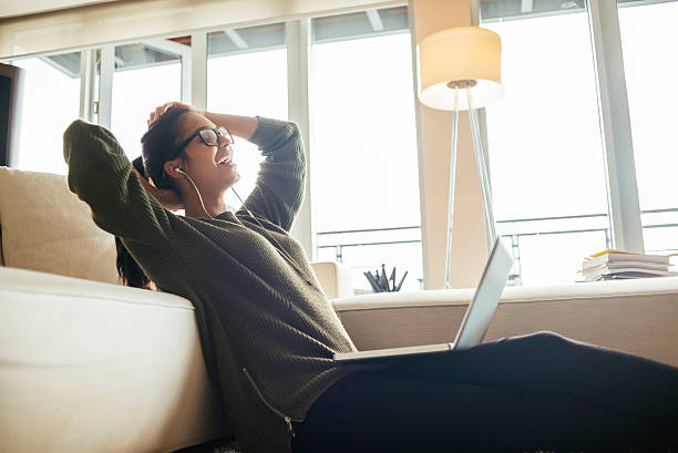 istock cheerful young woman relaxing after using her laptop 621861272