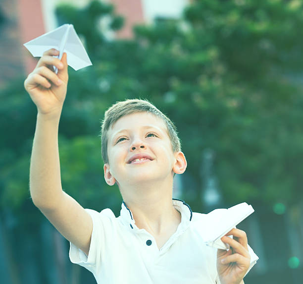 istock boy plaiing with toy airplane 621861688