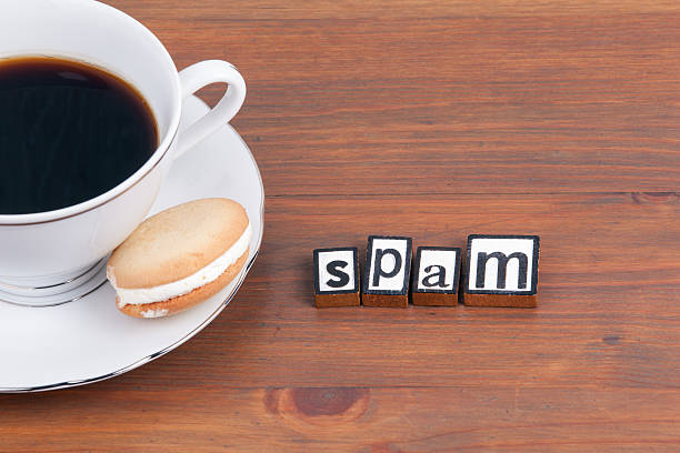 istock Coffee cup on a wooden table and text - Spam 621862026