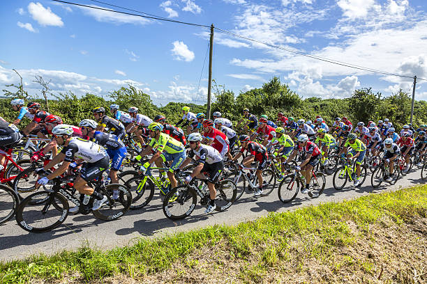 Mark Cavendish inThe Peloton - Tour de France 2016 Quineville, France - July 2, 2016: The Manx cyclist Mark Cavendish of Team Dimension Data riding in the pack during the first stage of Tour de France in Quineville, France on July 2, 2016. Cavendish won this stage. 2016 stock pictures, royalty-free photos & images