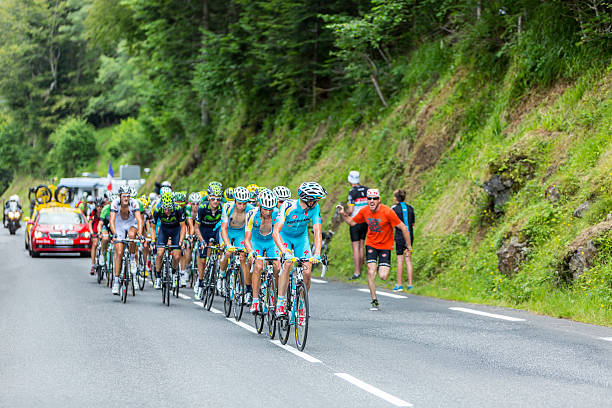 The Peloton - Tour de France 2014 Col Du Tourmalet, France - July 24, 2014: Astana Team in front of a part of the peloton climbing the road to Col de Tourmalet in the stage 18 of Le Tour de France 2014. tour de france stock pictures, royalty-free photos & images