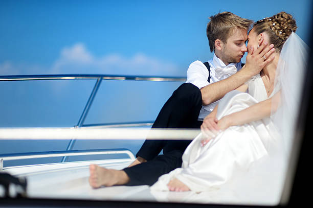 istock Happy bride and groom on a yacht 621893400