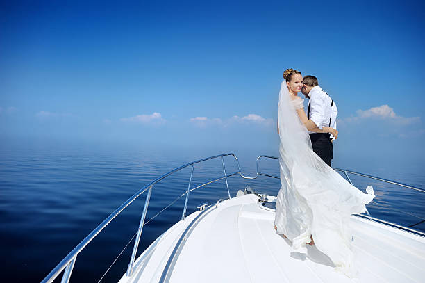 istock Happy bride and groom on a yacht 621893460