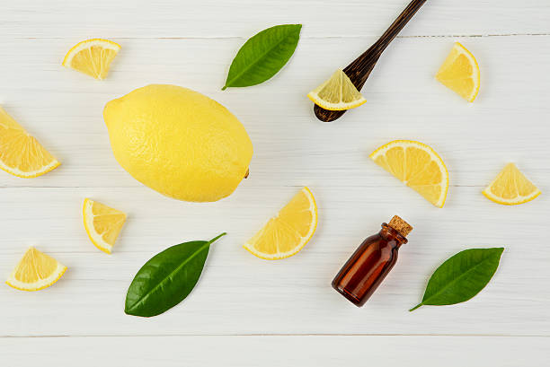 istock Fresh lemons and leaves with essential oil on rustic wood 621893794