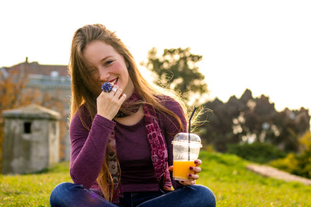 istock Young girl drinking fresh orange juice 621894116