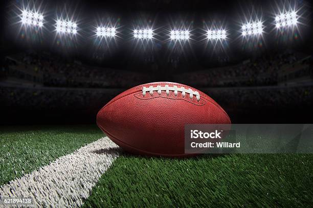 Professional Style Football On Field With Stripe Under Stadium Lights Stock Photo - Download Image Now