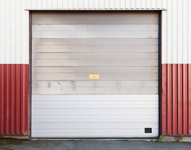 istock Closed gate in red white metal warehouse wall 621895066