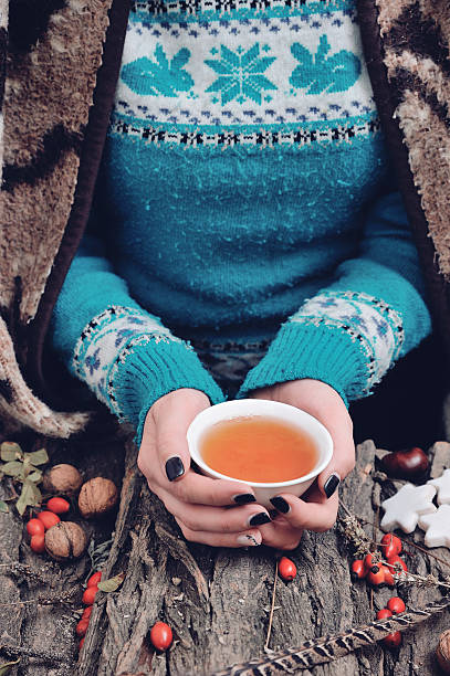istock Top view of woman's hands holding a hot tea cup 621896482