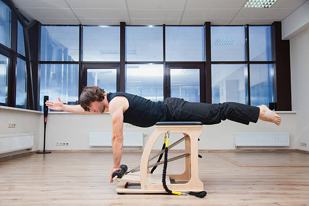 istock Man on pilates equipment. Fit and slim. 621896816