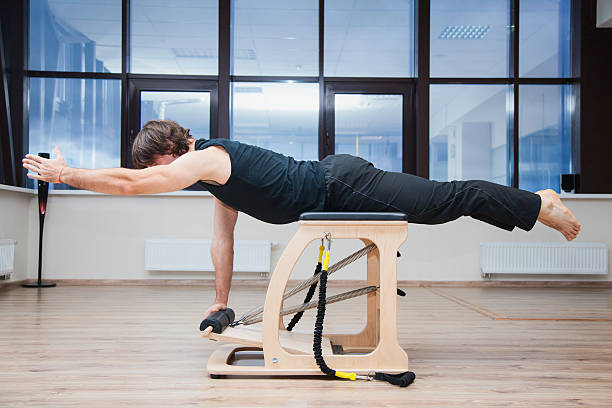 istock Man on pilates equipment. Fit and slim. 621896914