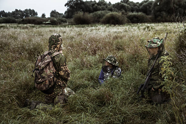 istock Dramatic hunting scene with group of hunters in bushes 621900324