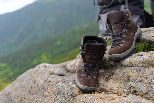 istock Perfect camping. Close up of boots and rucksack 621901874