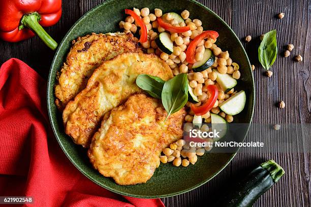 Roasted Pork Cutlets Coated In Cheese And Breadcrumbs Stock Photo - Download Image Now