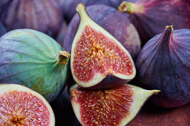 istock Fresh fig fruits on a wooden table 621903590