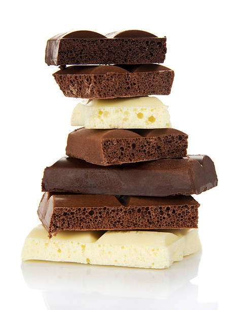istock Stack of porous pieces milk and black chocolate isolated. 621904062