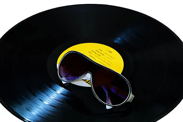 vinyl record on white background and sunglasses