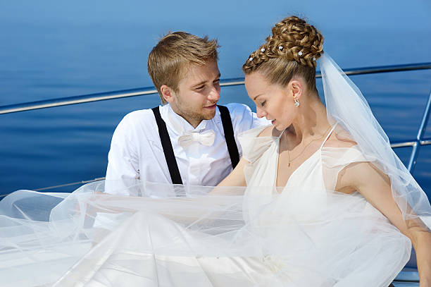 istock Happy bride and groom on a yacht 621905752