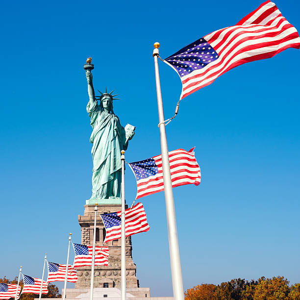 istock Statue of Liberty Surrounded by American Flags 621905938