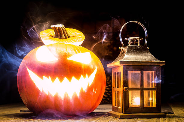 istock Halloween pumpkin with lantern and mystic smoke 621907460