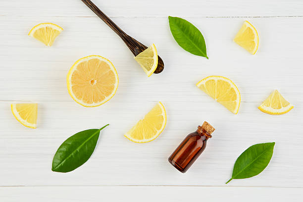 istock Fresh lemons and leaves with essential oil on rustic wood 621907552