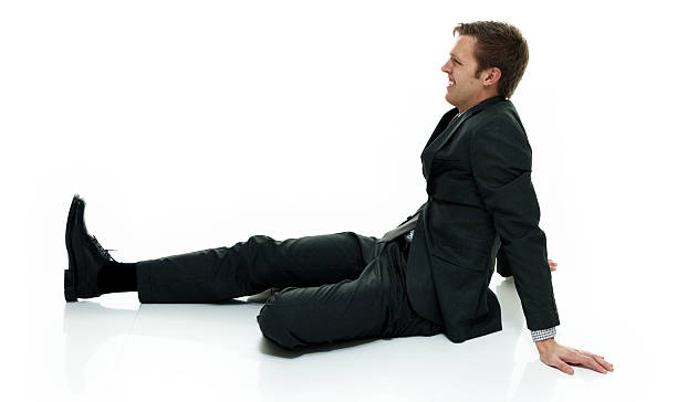 istock Smiling businessman sitting on floor 621908298