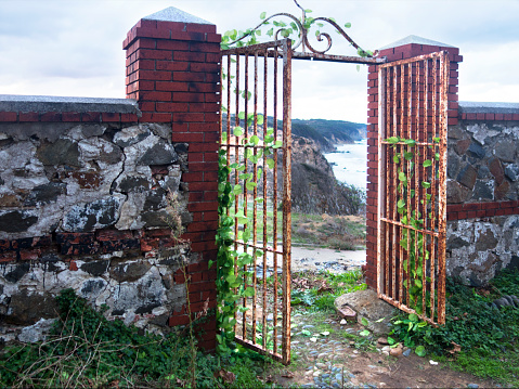 garden gate and  stone walls with red metal door