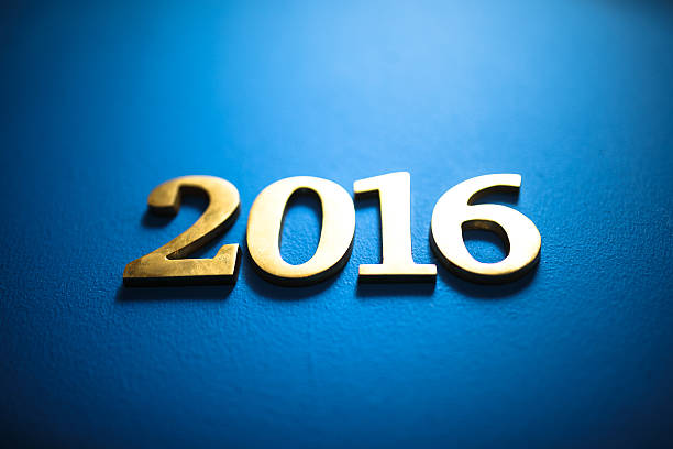 istock New year 2016 gold text on blue background 621909338