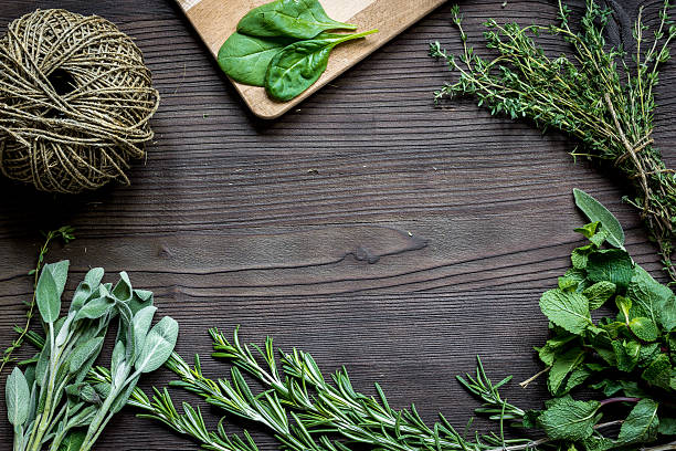 istock fresh herb frame on dark wooden background top view 621911588