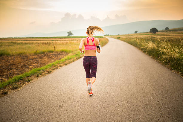 istock Woman jogging outdoors 621913156