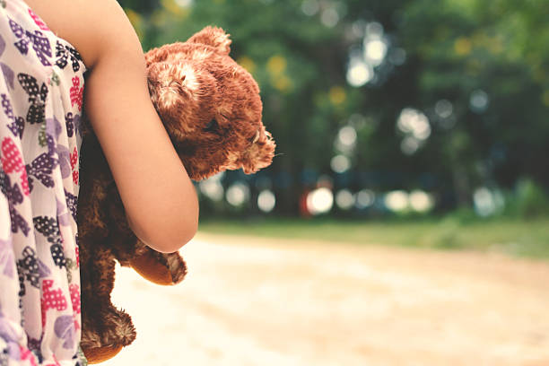 istock Little girl with teddy bear 621913340