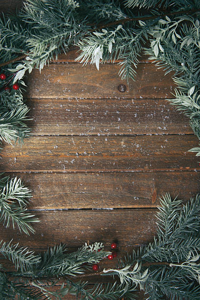 holiday background with fir branches Christmas background with fir branches on wood, sprinkled with snow. winter food top view stock pictures, royalty-free photos & images