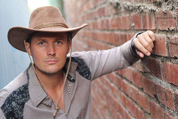 istock Young handsome man wearing cowboy hat 621916066