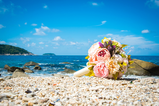 Beautiful wedding bouquet On the sand and sea.