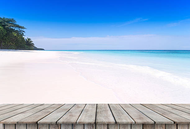 istock wooden table with Sand beach and tropical sea. 621919496