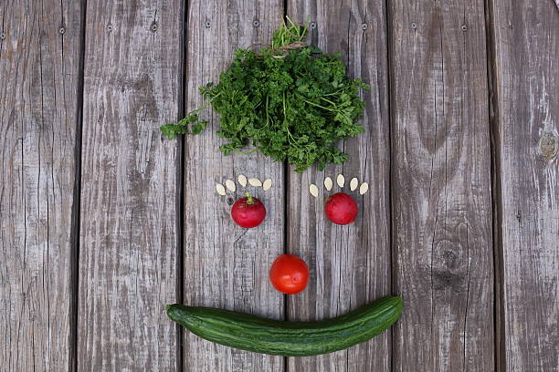 istock vegetable face on the wood distressed floor 621920122