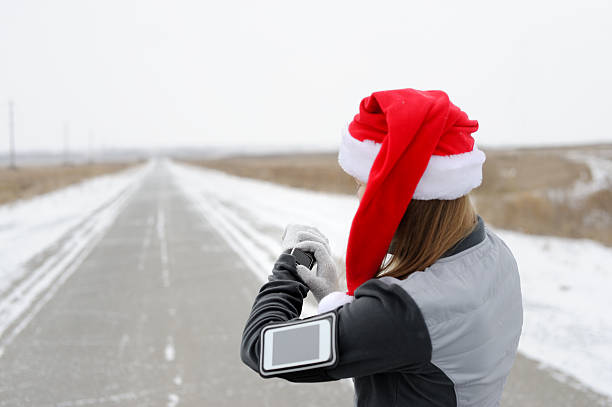 Smart Watch for sports. Jogging training for marathon. Santa hat. Happy New Year!