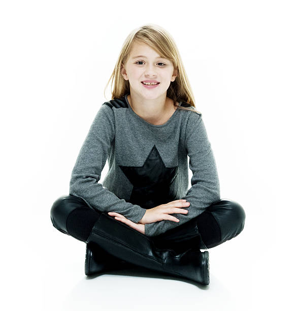 istock Smiling little girl sitting on floor 621921534